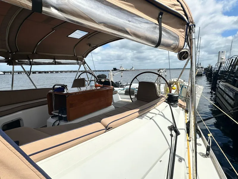 Slide: The Image of 2011 Jeanneau Sun Odyssey 45 DS sailboat docked, featuring spacious deck and helm. - 17