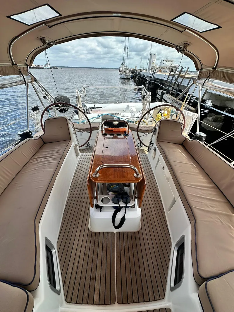 Slide: The Image of 2011 Jeanneau Sun Odyssey 45 DS sailboat cockpit with dual steering wheels and teak flooring. - 19