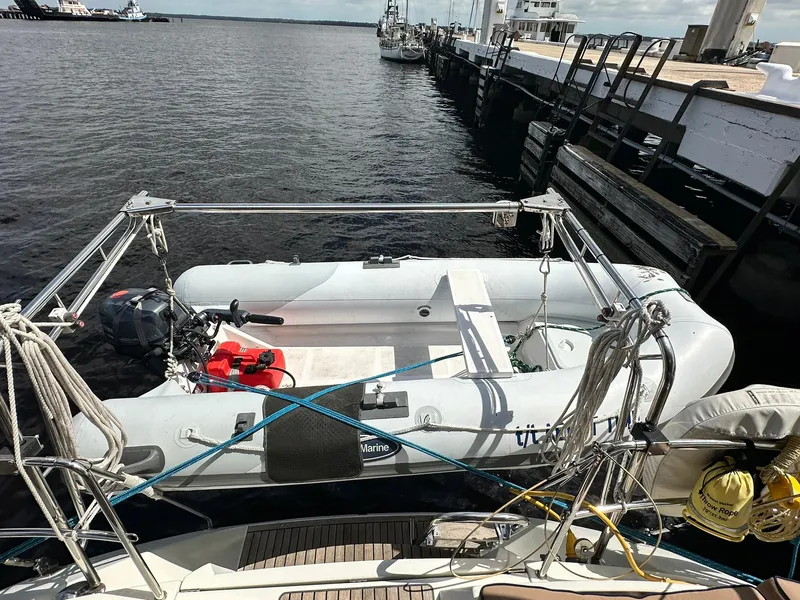 Slide: The Image of Inflatable dinghy secured on Jeanneau Sun Odyssey 45 DS, 2011 model, docked at marina. - 24