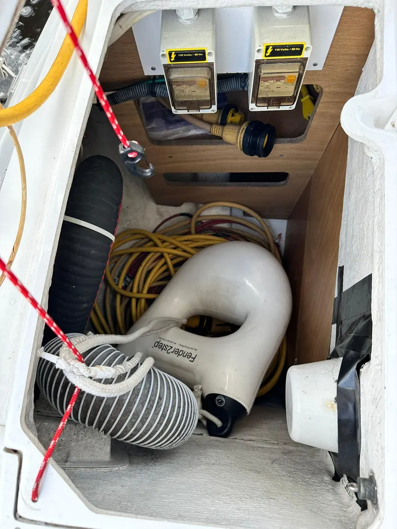 Slide: The Image of Storage compartment of 2011 Jeanneau Sun Odyssey 45 DS with hoses and cables. - 27