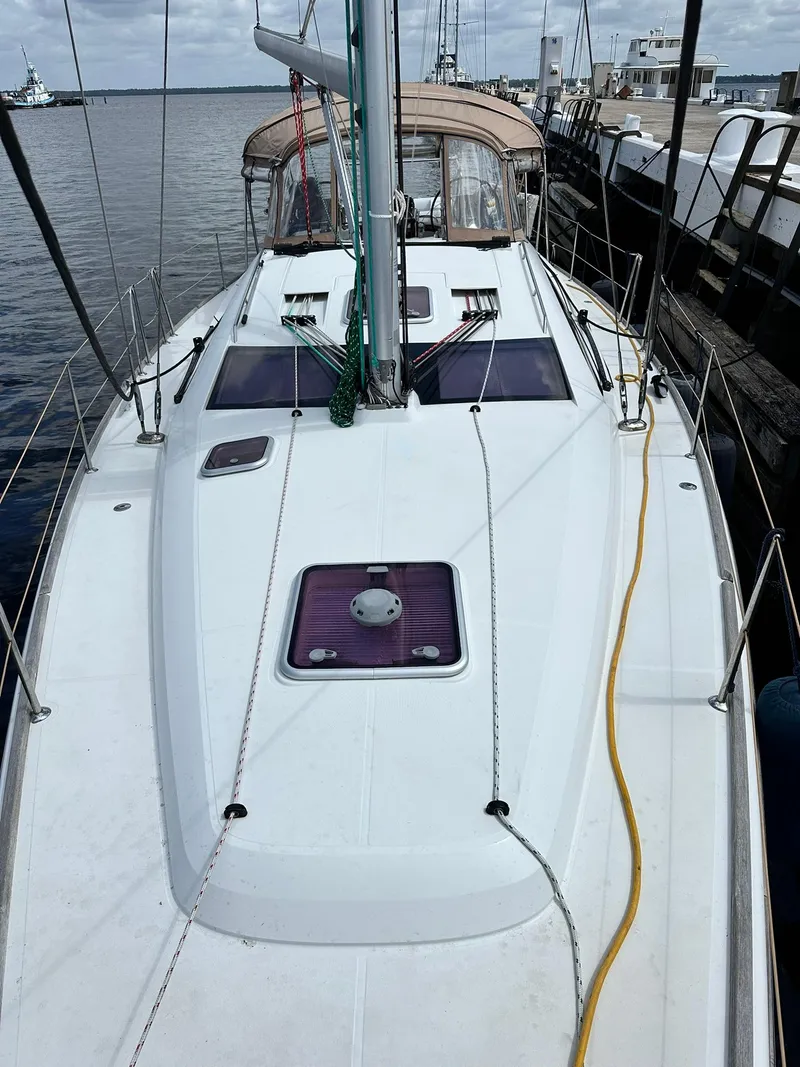 Slide: The Image of 2011 Jeanneau Sun Odyssey 45 DS sailboat docked, showcasing deck and cabin features. - 4