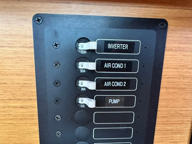 Slide: The Image of Electrical panel on 2011 Jeanneau Sun Odyssey 45 DS yacht, featuring inverter and air conditioning controls. - 43