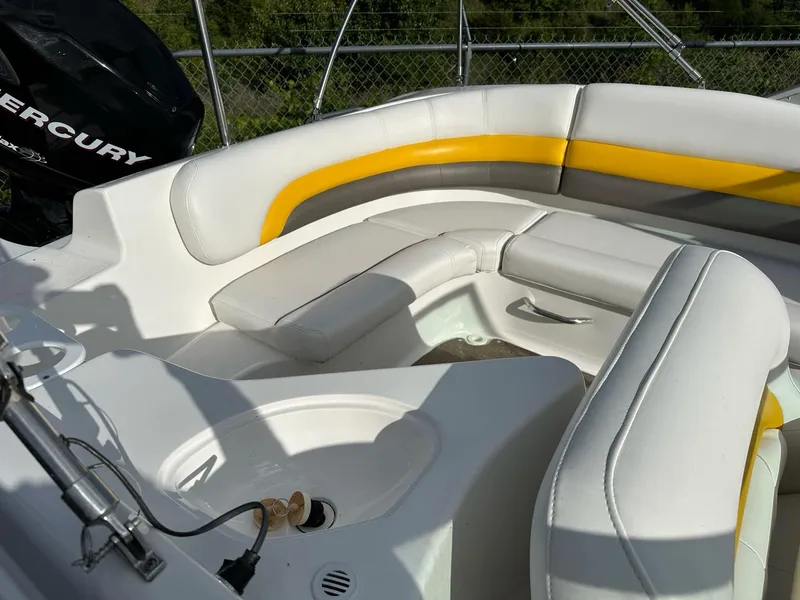 Slide: The Image of 2012 Hurricane SunDeck 237 OB boat interior with white and yellow seating. - 15