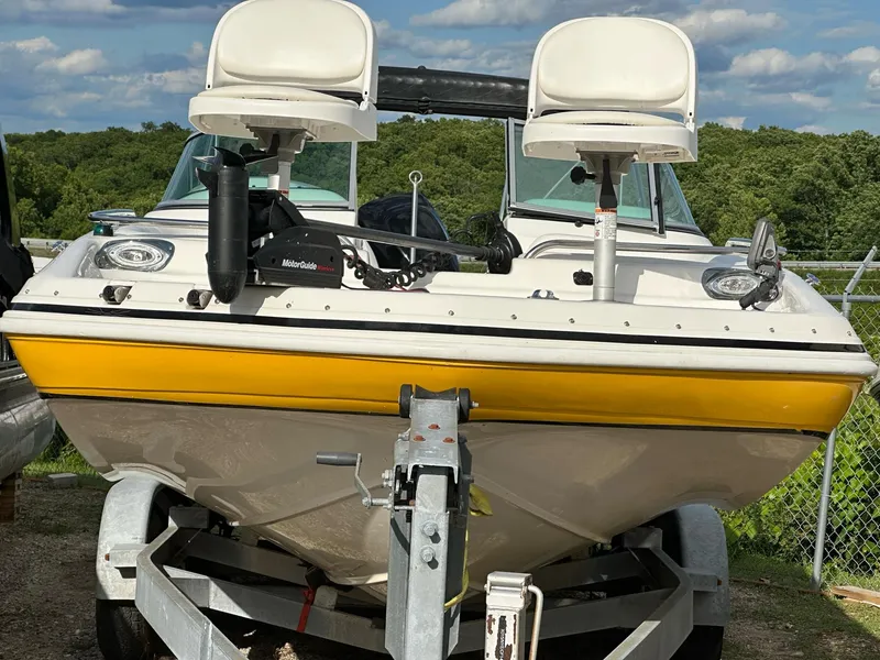 Slide: The Image of 2012 Hurricane SunDeck 237 OB boat on trailer, featuring dual seats and yellow trim. - 17