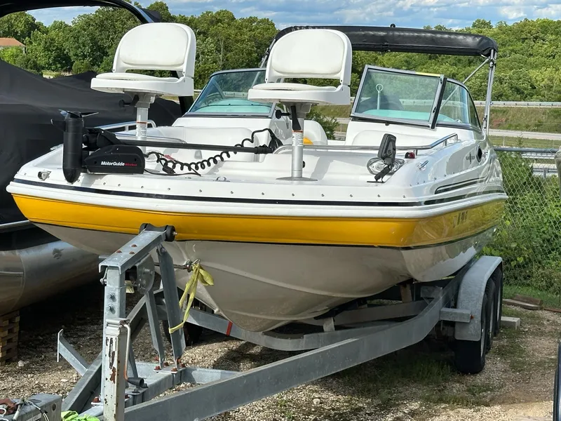 Slide: The Image of 2012 Hurricane SunDeck 237 OB boat on trailer, featuring dual seats and yellow trim. - 18
