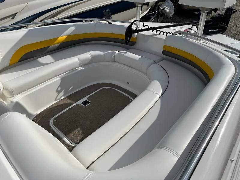 Slide: The Image of 2012 Hurricane SunDeck 237 OB boat interior with white and yellow seating. - 19