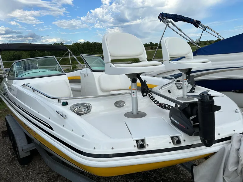 Slide: The Image of 2012 Hurricane SunDeck 237 OB boat with dual seats and motor, docked outdoors. - 20