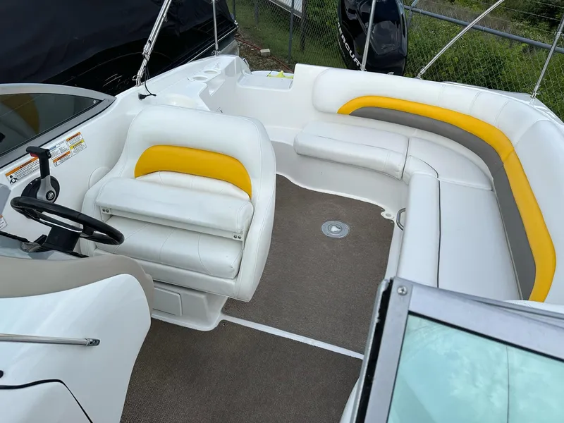 Slide: The Image of 2012 Hurricane SunDeck 237 OB boat interior with white and yellow seating. - 22