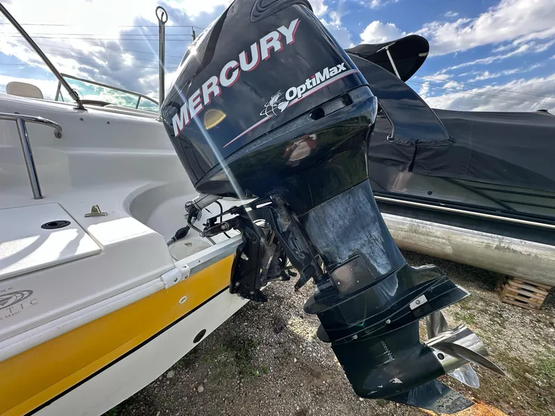 Slide: The Image of 2012 Hurricane SunDeck 237 OB with Mercury OptiMax outboard motor, docked outdoors. - 4
