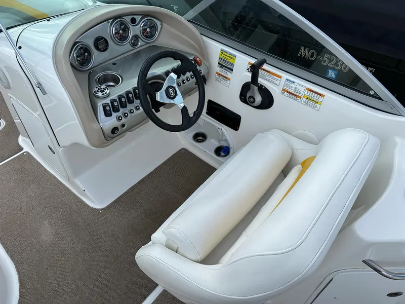 Slide: The Image of 2012 Hurricane SunDeck 237 OB boat cockpit with steering wheel and control panel. - 5