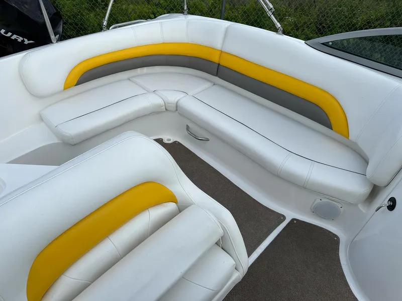 Slide: The Image of 2012 Hurricane SunDeck 237 OB boat interior with white, yellow, and gray seating. - 8
