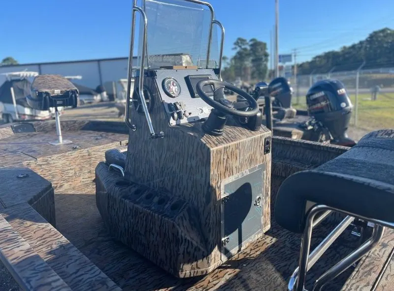 Slide: The Image of 2024 Xpress H20B boat with camo design, featuring a central console and steering wheel. - 3