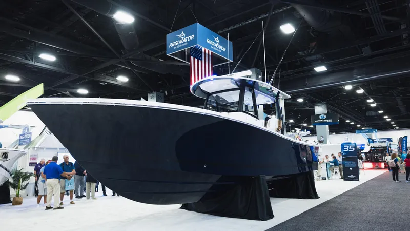 Slide: The Image of 2026 Regulator 35 boat displayed at an indoor exhibition, showcasing sleek design and modern features. - 1