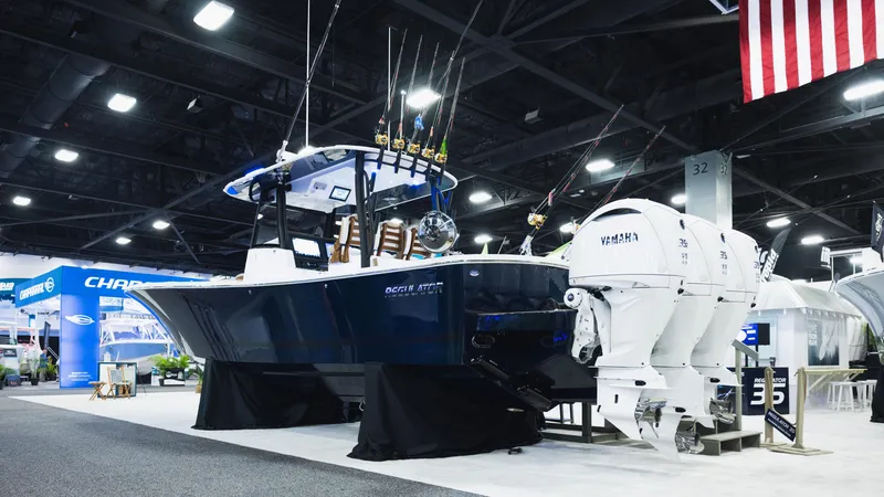 Slide: The Image of 2026 Regulator 35 boat with triple Yamaha engines displayed at an indoor boat show. - 2
