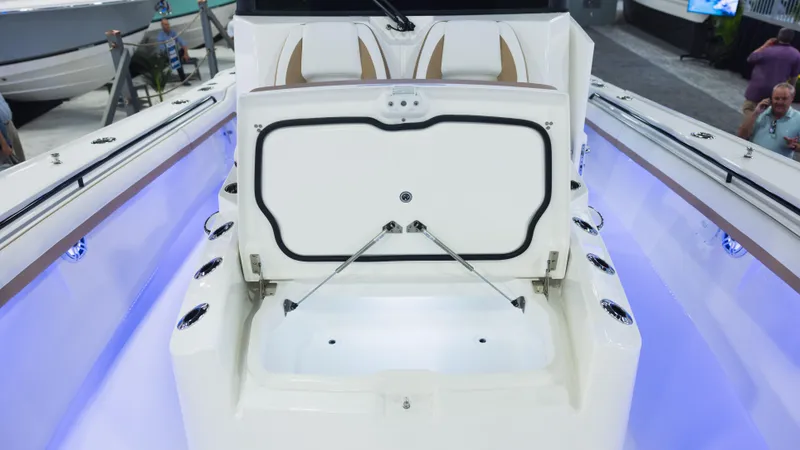 Slide: The Image of 2026 Regulator 35 boat with open storage compartment, illuminated interior, and sleek design. - 6