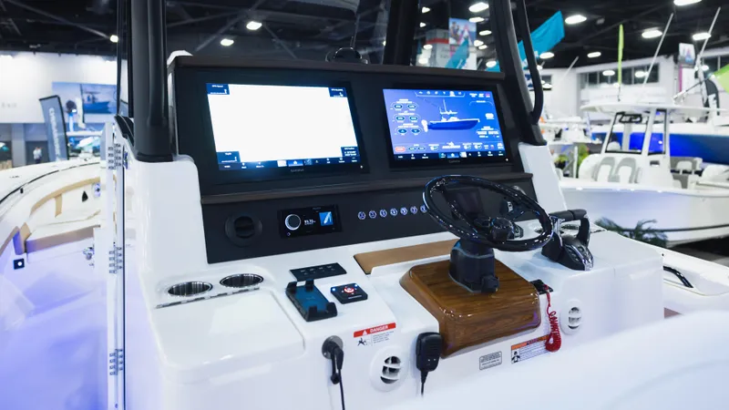 Slide: The Image of 2026 Regulator 35 boat dashboard with dual screens and steering wheel in a showroom setting. - 9