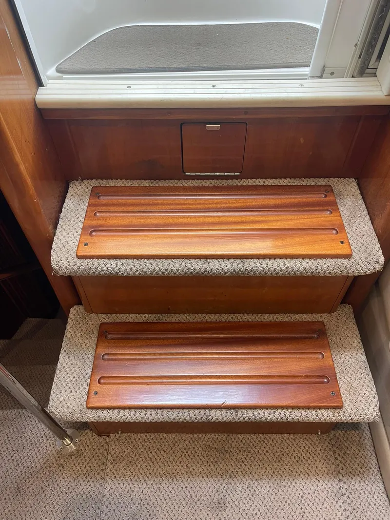 Slide: The Image of Staircase inside 2000 Carver 506 Motor Yacht with wooden steps and carpeted edges. - 12