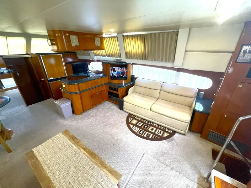 Slide: The Image of Interior of 2000 Carver 506 Motor Yacht with cozy seating and entertainment area. - 13