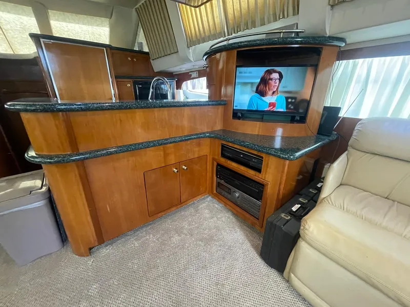 Slide: The Image of Interior of 2000 Carver 506 Motor Yacht with wood cabinetry and TV. - 14