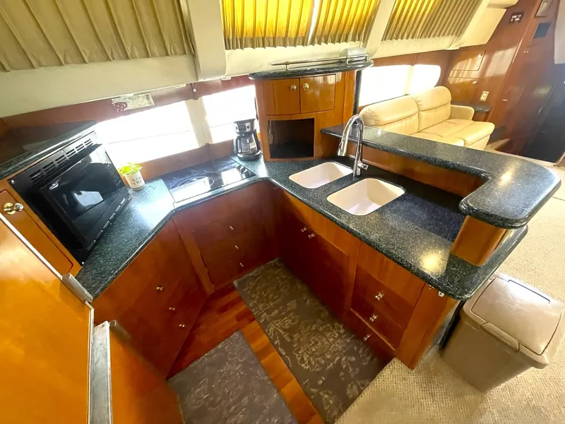 Slide: The Image of Interior of 2000 Carver 506 Motor Yacht with modern kitchen and seating area. - 18