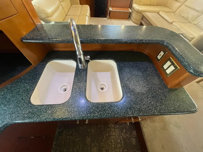 Slide: The Image of Luxurious kitchen sink area in 2000 Carver 506 Motor Yacht with dual basins. - 22