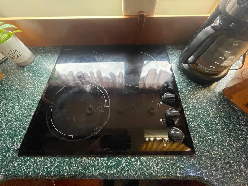Slide: The Image of Stovetop on Carver 506 Motor Yacht, 2000 model, with coffee maker and green countertop. - 23