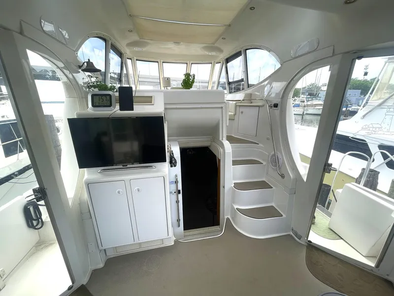 Slide: The Image of Interior of 2000 Carver 506 Motor Yacht with TV, stairs, and windows. - 42