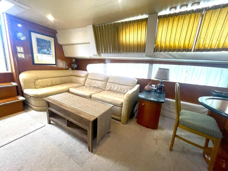 Slide: The Image of Luxurious interior of 2000 Carver 506 Motor Yacht with beige seating and wooden accents. - 10