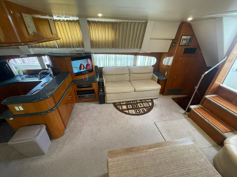 Slide: The Image of Interior of 2000 Carver 506 Motor Yacht with cozy seating and entertainment area. - 11