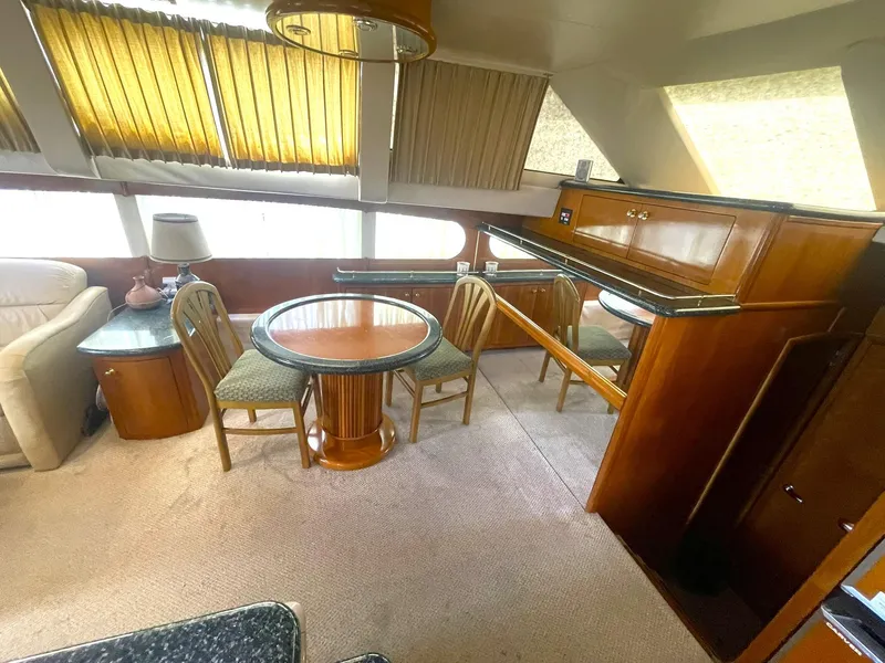 Slide: The Image of Interior of 2000 Carver 506 Motor Yacht with dining area and wooden furnishings. - 15
