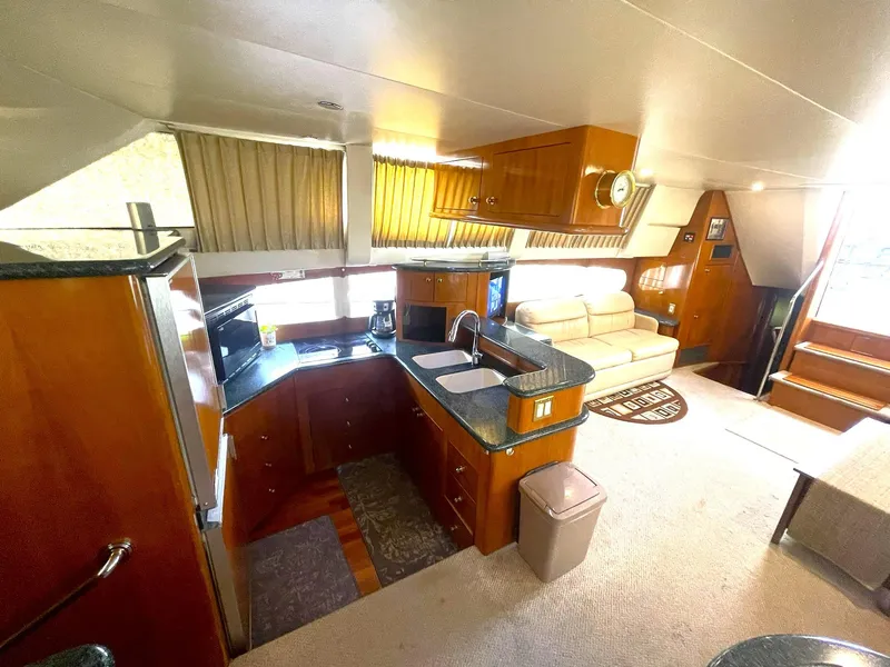 Slide: The Image of Interior of 2000 Carver 506 Motor Yacht with kitchen and seating area. - 16