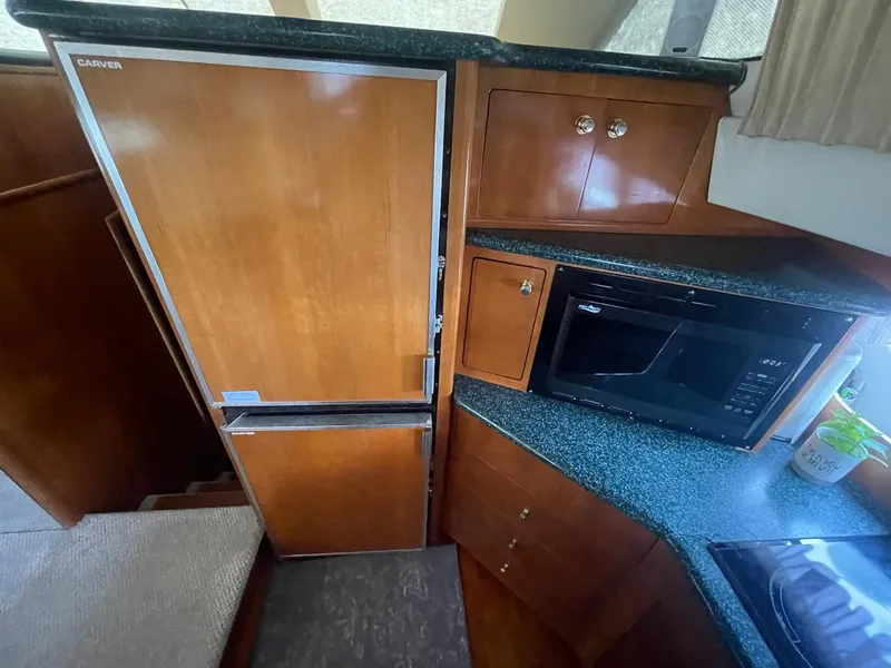 Slide: The Image of Interior of 2000 Carver 506 Motor Yacht kitchen with fridge and microwave. - 21
