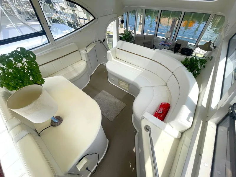 Slide: The Image of Luxurious interior of 2000 Carver 506 Motor Yacht with white seating and large windows. - 28