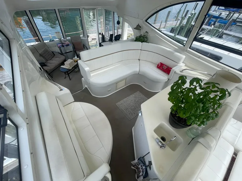 Slide: The Image of Interior of 2000 Carver 506 Motor Yacht with white seating and potted plant. - 29