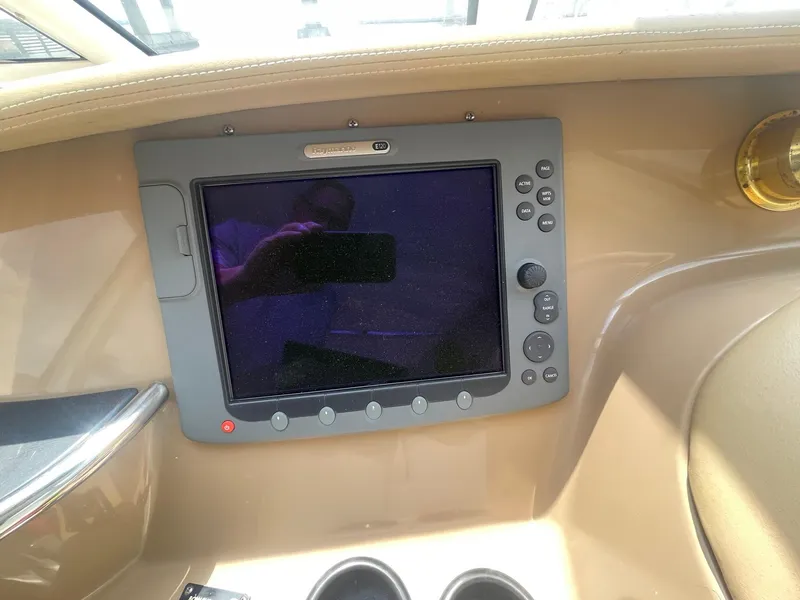 Slide: The Image of Control panel of a 2000 Carver 506 Motor Yacht, featuring a navigation screen. - 34