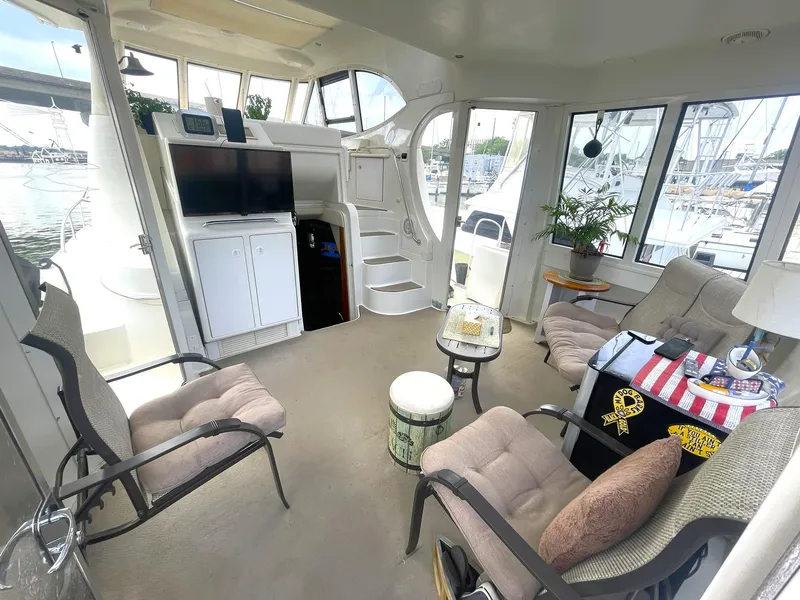 Slide: The Image of Interior of 2000 Carver 506 Motor Yacht with seating, TV, and decor. - 40