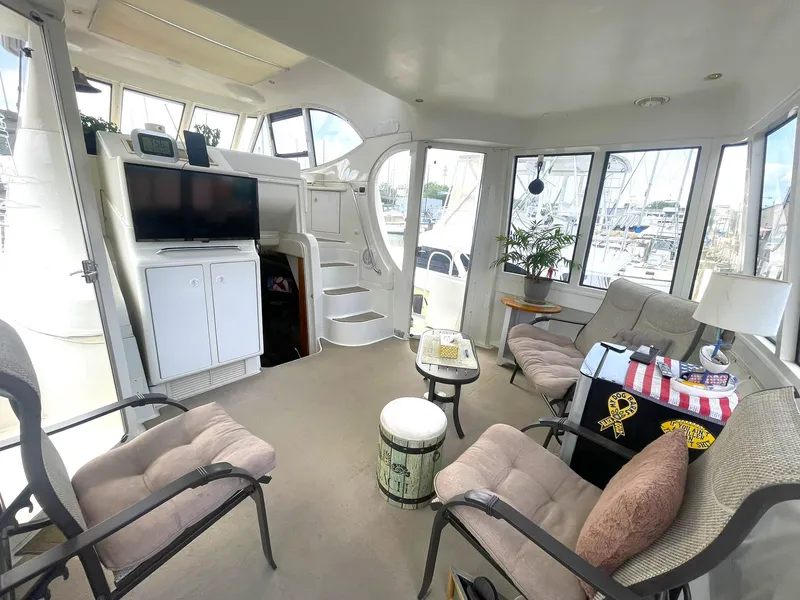 Slide: The Image of Interior of 2000 Carver 506 Motor Yacht with seating, TV, and windows. - 41