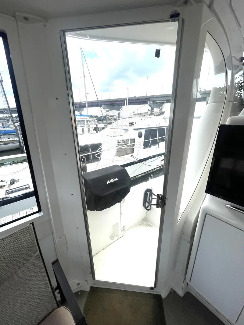 Slide: The Image of Interior view of a 2000 Carver 506 Motor Yacht, showing a door leading to the deck. - 49