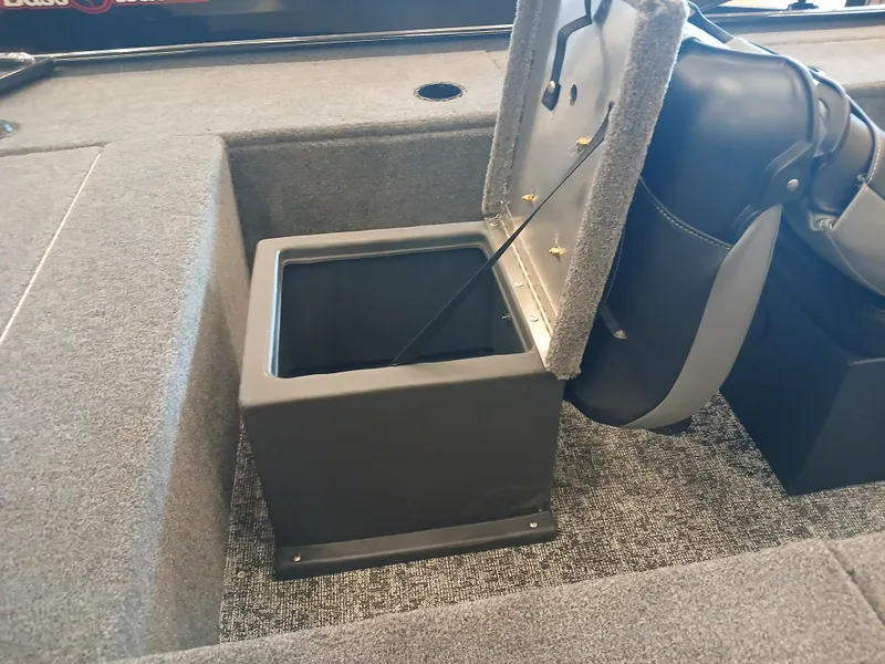 Slide: The Image of 2025 Tracker Panfish 17 boat storage compartment with open lid, showcasing interior space. - 12