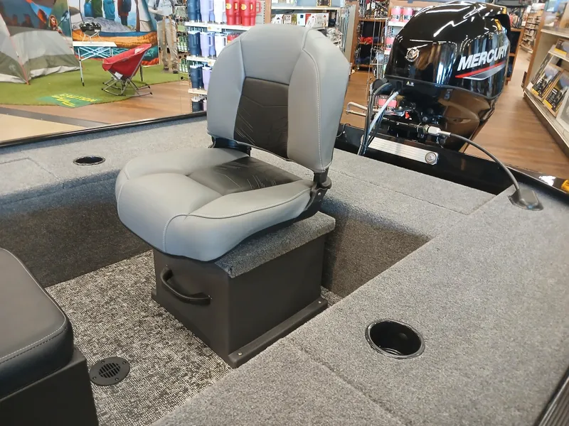 Slide: The Image of 2025 Tracker Panfish 17 boat interior with seating and Mercury engine in a showroom. - 13