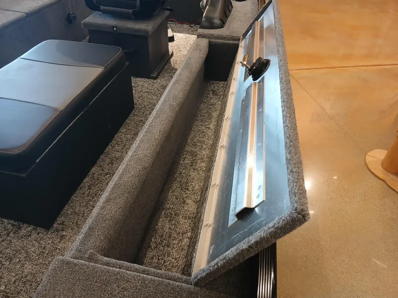 Slide: The Image of 2025 Tracker Panfish 17 boat interior with open storage compartment and seating. - 14