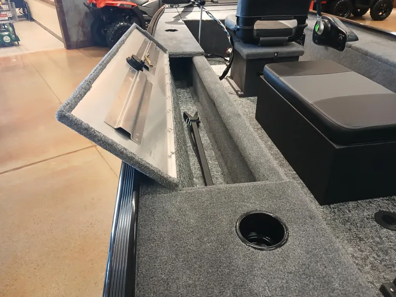 Slide: The Image of 2025 Tracker Panfish 17 boat interior with open storage compartment and seating. - 15