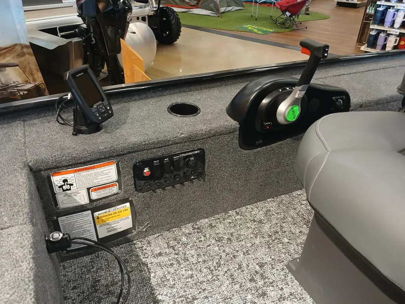 Slide: The Image of 2025 Tracker Panfish 17 boat interior with control panel and seating. - 5