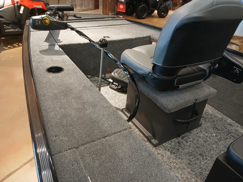 Slide: The Image of 2025 Tracker Panfish 17 boat interior with seating and steering controls. - 7