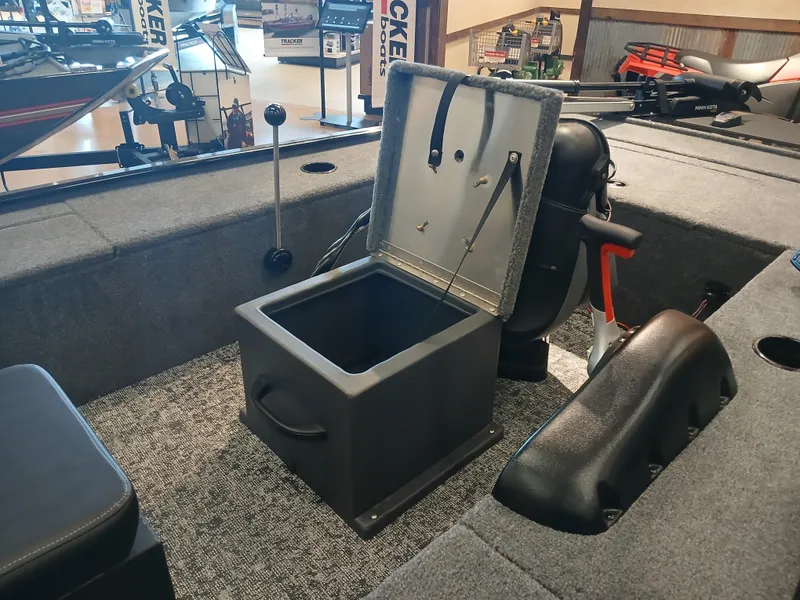 Slide: The Image of 2025 Tracker Panfish 17 boat interior with open storage compartment and seating. - 8