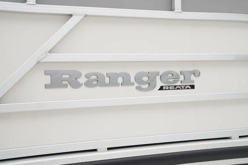 Slide: The Image of 2025 Ranger Reata 243C boat console with steering wheel and navigation controls. - 17
