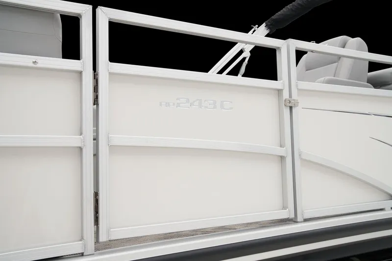 Slide: The Image of 2025 Ranger Reata 243C pontoon boat on trailer, foggy landscape. - 19