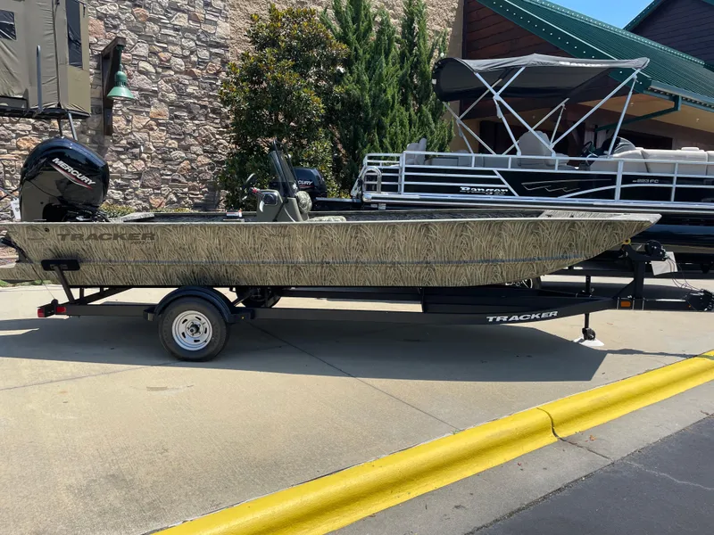The Image of 2025 Tracker Grizzly 2072 CC boat on trailer, parked outdoors. - 0