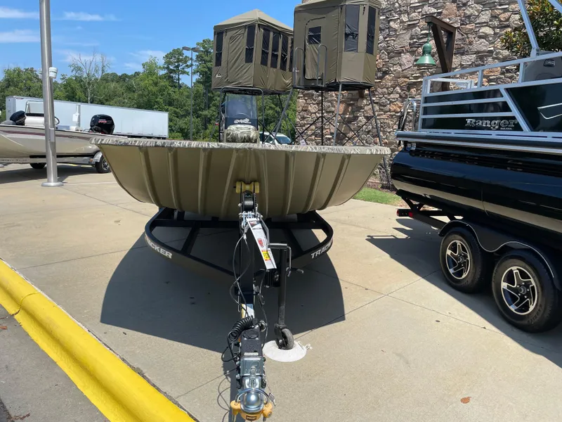 Slide: The Image of 2025 Tracker Grizzly 2072 CC boat on trailer, displayed outdoors. - 2