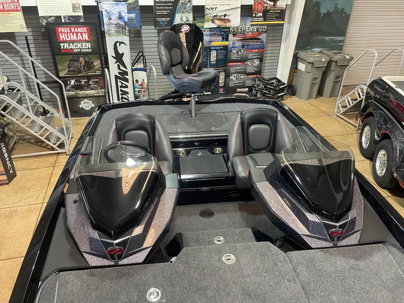 Slide: The Image of 2025 Ranger Z518 boat interior with dual seats and sleek design in showroom. - 11